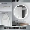 A bathroom scene featuring a round LED mirror, with instructional steps for mounting shown on the left. Anteprima dell’immagine prodotto