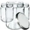 Several empty glass jars are arranged together, with one lid placed in the foreground. Produktbild-Vorschau