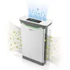 A white and gray air purifier is shown on a white background, with green particles representing pollutants being drawn into the device and blue particles representing clean air being expelled. Produktbild-Vorschau