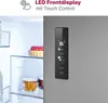 Close-up of a modern refrigerator door with a digital display and the interior of the refrigerator visible. Produktbild-Vorschau