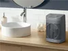 A bathroom counter with a sink, faucet, soap dispenser, cotton balls, and a portable heater. Anteprima dell’immagine prodotto