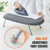 A person is ironing on a small ironing board placed on a white surface. A close-up inset shows the adjustable foot cover of the ironing board. Produktbild-Vorschau