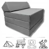 A folded mattress with a headrest, shown from a diagonal angle against a white background. Below the mattress are four icons representing camping, a caravan, sleeping, and yoga. Produktbild-Vorschau