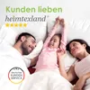 A family (father, mother, daughter) lying in bed, smiling and stretching. Náhled obrázku produktu