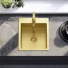 A top-down view of a gold sink with a gold faucet on a grey countertop. Podgląd zdjęcia produktu