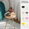 A small wooden side table with a vase of flowers and a smartphone on it, next to a couch and a window with curtains. A collage of different colored side tables is shown on the right. Produktbild-Vorschau