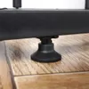 A close-up shot of the black adjustable foot of a metal plant stand resting on a wooden floor. Náhled obrázku produktu