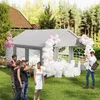 People gathered around a party tent decorated with balloons, with a table set up inside. Voir les images du produit
