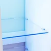Interior view of a white cabinet with glass shelves. Produktbild-Vorschau