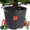 A Christmas tree stand with gifts and ornaments around it. Voir les images du produit