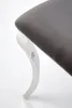 A close-up view of a chair leg and seat. Voir les images du produit