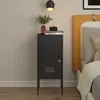 A bedside table with items on top, next to a bed. Anteprima dell’immagine prodotto