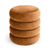 A stack of four round, brown velvet ottomans. Podgląd zdjęcia produktu