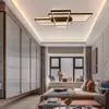 A modern bedroom with a large window, bed, and wardrobe, featuring a geometric ceiling light. Náhľad obrázku produktu
