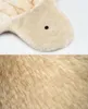 A close-up view of a beige furry material, likely a pet bed or cushion, with a small dark circle visible on the upper portion. Produktbild-Vorschau