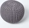 A close-up, studio shot of a gray knitted pouf on a white background. Náhled obrázku produktu