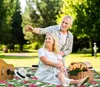An elderly couple enjoying a picnic in a park. Náhled obrázku produktu