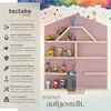 A pink wall shelf shaped like a house, filled with small toys and featuring descriptive text about its features. Produktbild-Vorschau