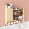 A wooden kitchen shelf unit mounted on a pink wall above a white tiled countertop. Podgląd zdjęcia produktu