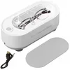 A white ultrasonic cleaner with glasses inside, shown with a USB cable and a lid. Voir les images du produit