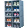 A stack of clear plastic shoe boxes with gray frames, each containing a pair of shoes. Produktbild-Vorschau