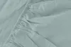 A close-up view of a light green fitted sheet with elastic gathering. Náhled obrázku produktu