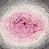 A close-up view of a ball of yarn with a gradient color transition from gray to pink. Podgląd zdjęcia produktu