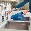 A person is cleaning a blue appliance part under a faucet in a kitchen sink. Produktbild-Vorschau