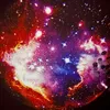 A projection of a colorful nebula and stars on a dark surface, with a decorative object in the foreground. Anteprima dell’immagine prodotto