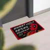A doormat with a cartoon character and text is placed in front of a doorway. Produktbild-Vorschau