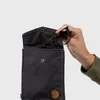 A hand is placing sunglasses into a black pouch. Produktbild-Vorschau