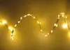 A string of warm white LED lights is shown against a gradient yellow background. Produktbild-Vorschau