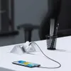 A smartphone is charging on a desk next to a power adapter and a pencil holder. Náhled obrázku produktu