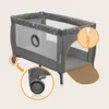 A travel crib with two highlighted features: a zipper on the side entrance and a wheel with a brake mechanism. Produktbild-Vorschau