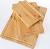 A stack of three bamboo cutting boards of varying sizes, arranged diagonally on a white background. Produktbild-Vorschau
