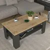 A coffee table with a plant and cups on it, placed in a living room setting next to a sofa. Produktbild-Vorschau