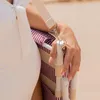 A person holding a striped beach chair strap. Produktbild-Vorschau