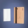 A white smartphone charging holder and its packaging are displayed against a blue and gray gradient background. Produktbild-Vorschau