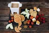 A fondue set with various dipping items arranged on a slate board. Náhled obrázku produktu