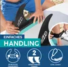 A person is attaching fins to a stand-up paddleboard on a beach. Produktbild-Vorschau