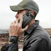 A man wearing a cap and jacket is on the phone, with a rugged phone case and a smartwatch visible. Produktbild-Vorschau