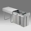 A gray pull-out trash can system with two compartments, shown extended from a cabinet. Náhľad obrázku produktu