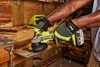 A person wearing work gloves is using a Ryobi angle grinder to cut metal, creating sparks. Produktbild-Vorschau
