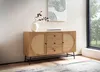 A wooden sideboard with cane detailing is placed in a well-lit room with a large window. Produktbild-Vorschau