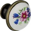 A close-up shot of a decorative ceramic drawer knob. Produktbild-Vorschau