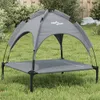 A dog bed with a canopy is set up on a grassy lawn in a backyard. Náhľad obrázku produktu