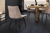 A dining room setting with chairs around a wooden table, overlooking a city view. Produktbild-Vorschau