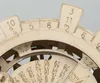 A close-up view of a wooden perpetual calendar mechanism with numbers and dials. Anteprima dell’immagine prodotto