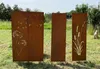 Three metal garden screens with decorative cutouts are placed in a grassy outdoor area with trees in the background. Produktbild-Vorschau