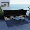 A pallet sofa with black cushions on a balcony overlooking the ocean. Voir les images du produit